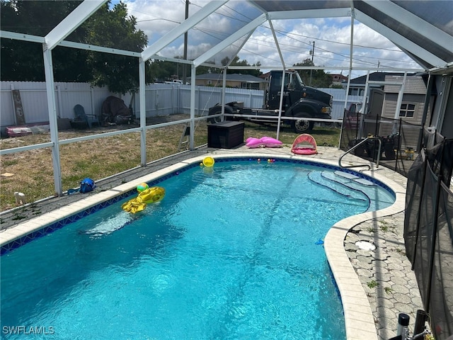 view of pool featuring glass enclosure