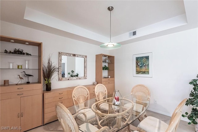 dining space featuring a tray ceiling