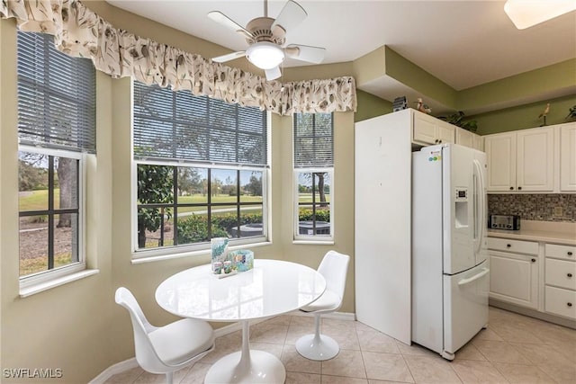 dining space featuring ceiling fan and light tile patterned flooring