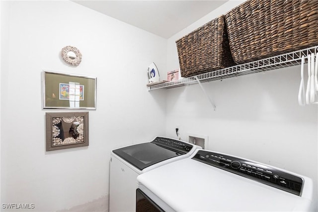 clothes washing area featuring washer and dryer