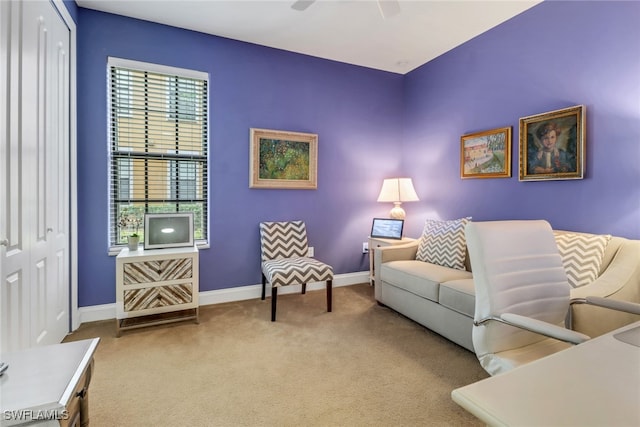 living room featuring ceiling fan, carpet flooring, and baseboards