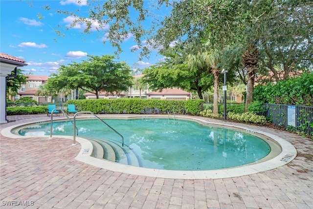 pool featuring a patio area and fence