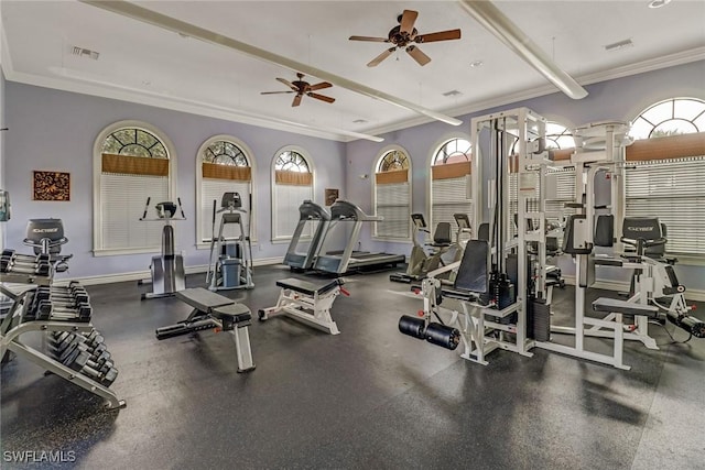 exercise room with visible vents, crown molding, and baseboards