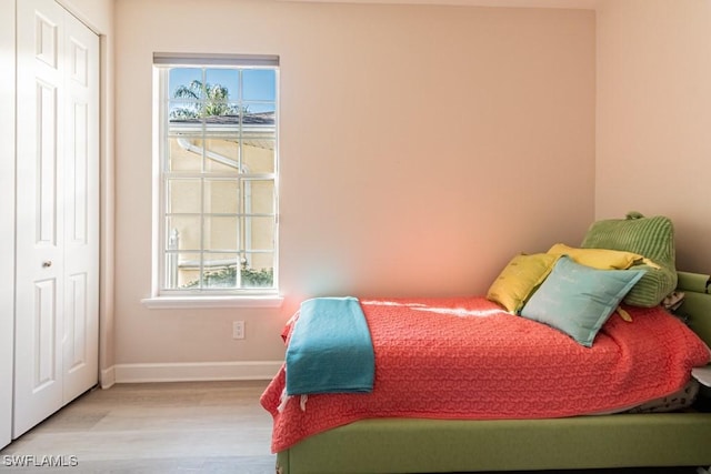 bedroom featuring light hardwood / wood-style flooring and a closet