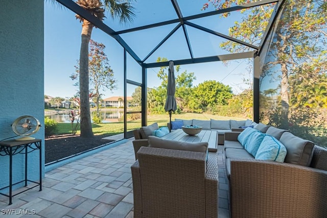 view of patio / terrace featuring a lanai, an outdoor living space, and a water view