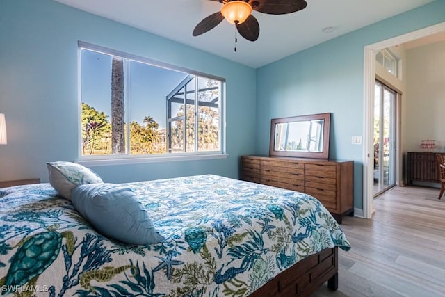 bedroom featuring ceiling fan, access to exterior, and light hardwood / wood-style flooring