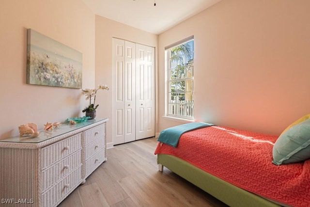 bedroom featuring light wood-type flooring and a closet