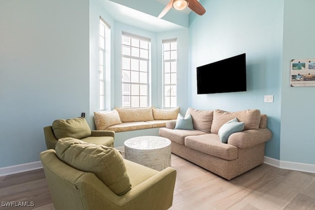 living room with hardwood / wood-style flooring and ceiling fan