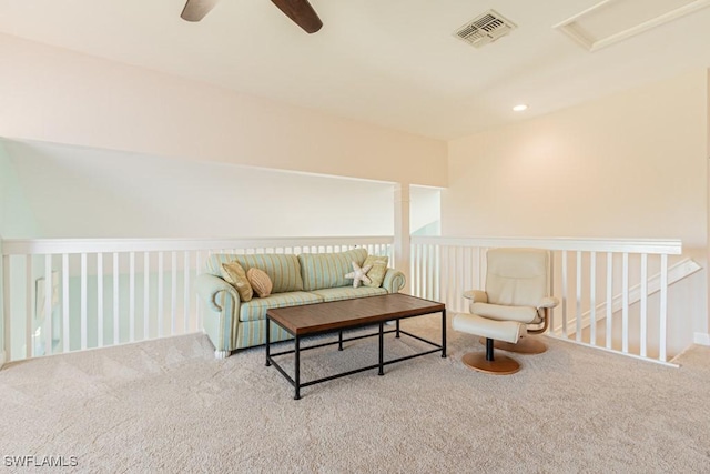 sitting room with ceiling fan and carpet flooring