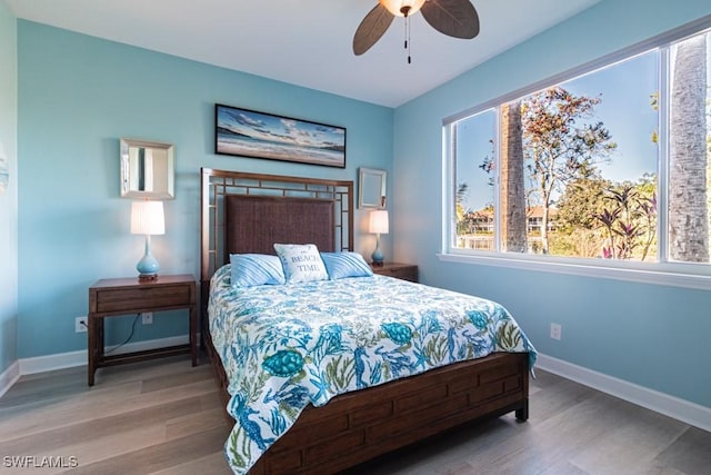 bedroom with ceiling fan and hardwood / wood-style flooring