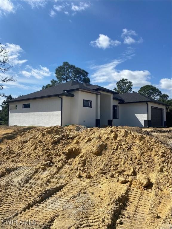 view of front of home featuring an attached garage and stucco siding