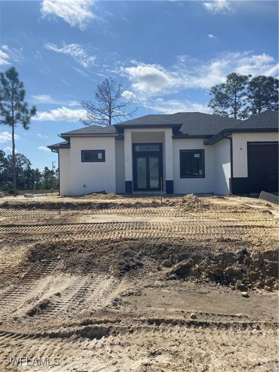 view of front of property with a garage and stucco siding