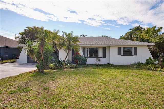 single story home featuring central AC unit and a front lawn