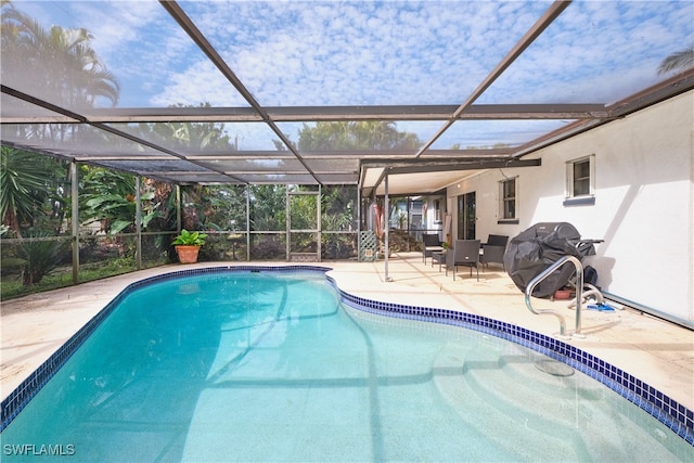 view of pool with a grill, a patio, and glass enclosure