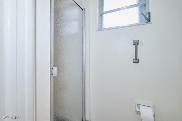 bathroom with a shower with shower door