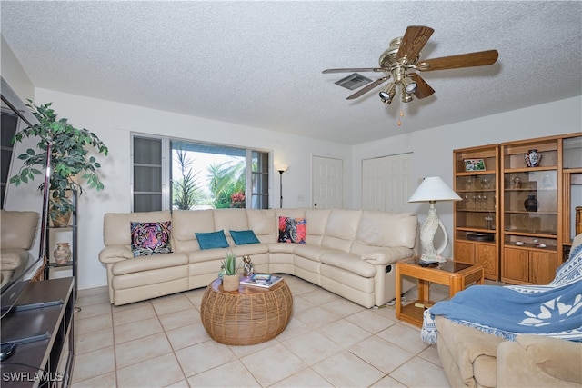 tiled living room featuring ceiling fan and a textured ceiling