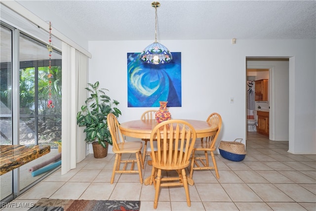 dining room with light tile patterned floors and a textured ceiling