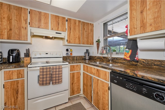 kitchen featuring sink, light tile patterned flooring, stainless steel dishwasher, white electric stove, and dark stone counters