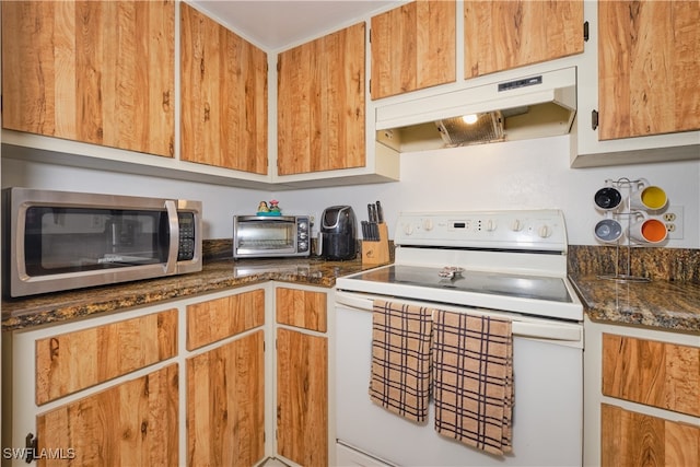 kitchen with dark stone countertops and electric range