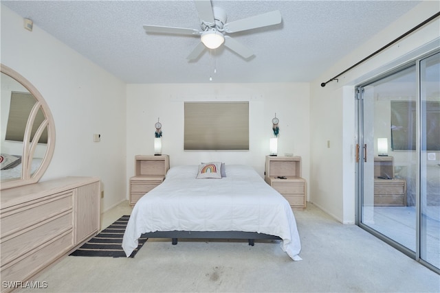 bedroom featuring access to exterior, light colored carpet, a textured ceiling, and ceiling fan