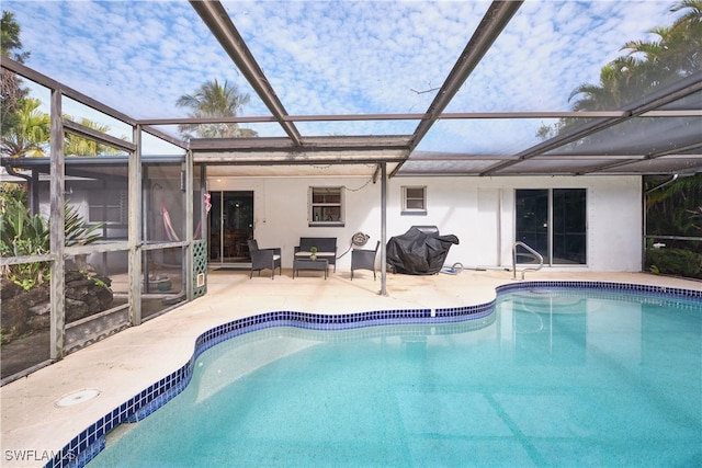 view of swimming pool with a grill, a lanai, and a patio area