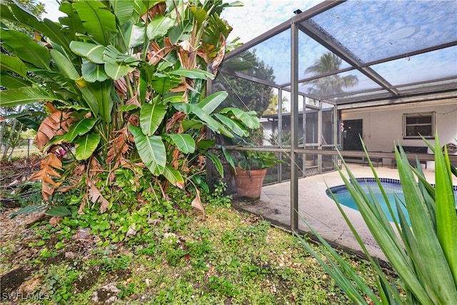 view of swimming pool with a lanai and a patio