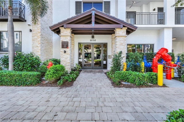 1030 3rd Ave S Unit 419, Naples, FL 34102 - doorway to property featuring french doors, stone siding, and stucco siding