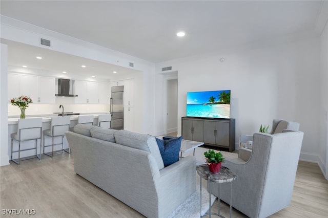 1030 3rd Ave S Unit 419, Naples, FL 34102 - living room with light wood finished floors, recessed lighting, and baseboards