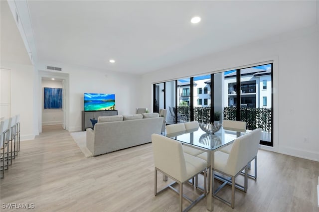 dining area featuring light wood-type flooring