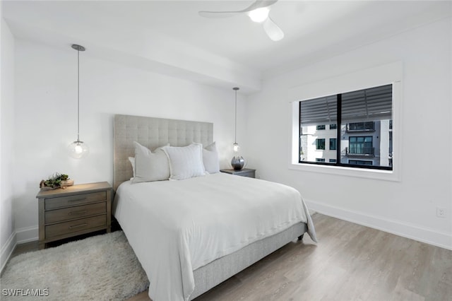 bedroom with ceiling fan and hardwood / wood-style flooring