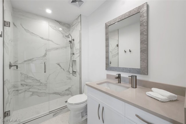 bathroom with a shower with shower door, toilet, and vanity