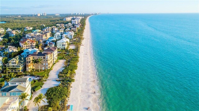 birds eye view of property featuring a water view and a beach view