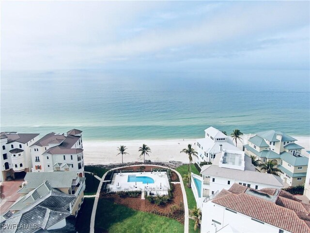 birds eye view of property with a water view and a view of the beach