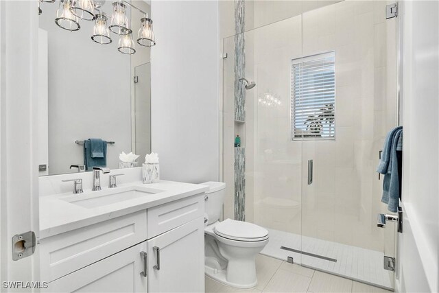 bathroom with toilet, vanity, an enclosed shower, and tile patterned flooring