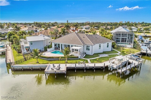 exterior space featuring a water view, a lanai, and a yard