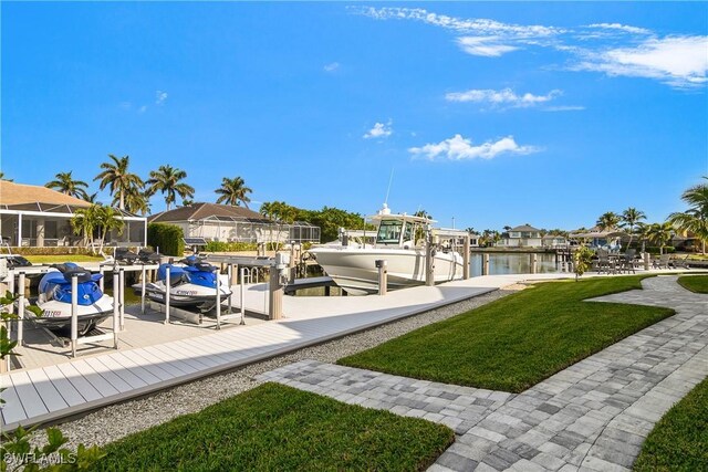 dock area featuring a lawn and a water view