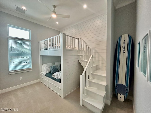 bedroom with light colored carpet, ceiling fan, and ornamental molding