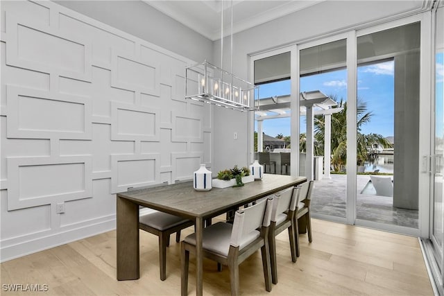 dining room featuring crown molding and light wood-type flooring