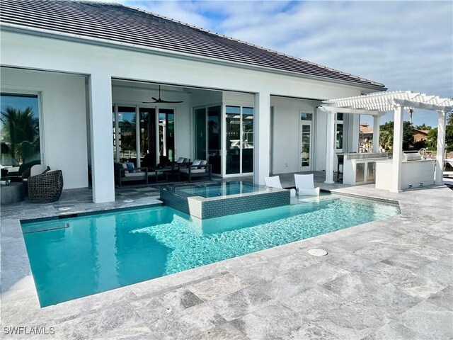 view of swimming pool with an outdoor living space, area for grilling, an in ground hot tub, exterior bar, and a pergola