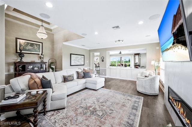 living room with hardwood / wood-style floors and crown molding