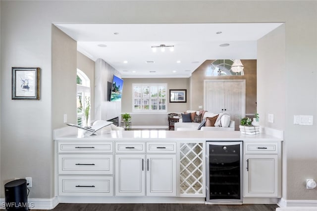 bar with white cabinetry and wine cooler