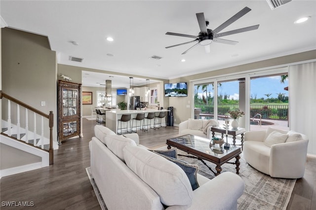 living room with ornamental molding, ceiling fan, and hardwood / wood-style floors