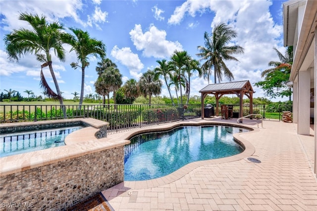 view of swimming pool with a gazebo, a patio area, and a jacuzzi