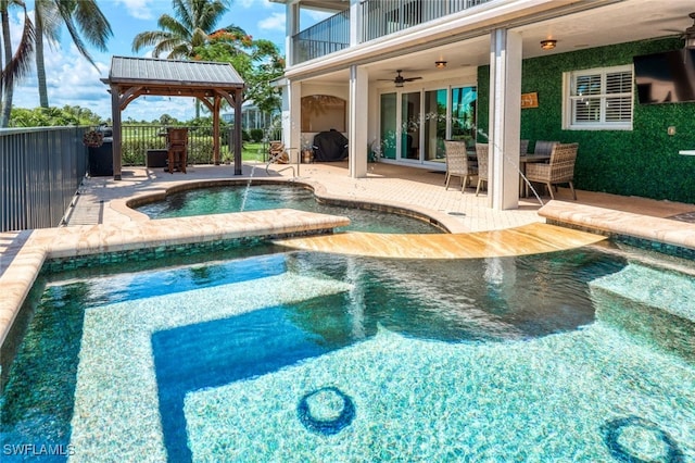 view of swimming pool featuring ceiling fan, a jacuzzi, a gazebo, and a patio area