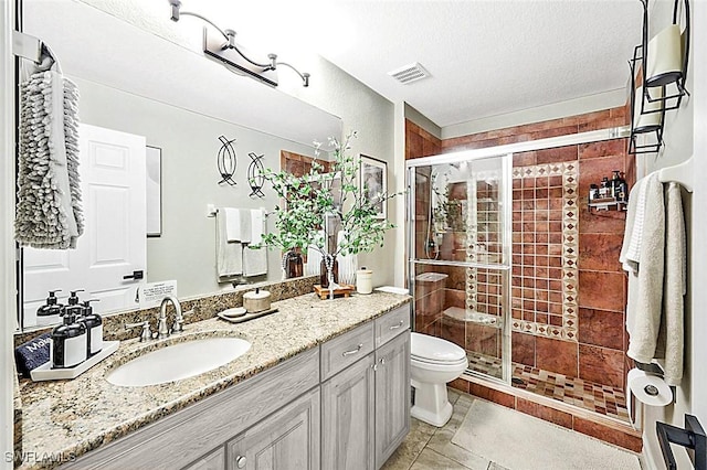 bathroom with toilet, an enclosed shower, vanity, and tile patterned floors