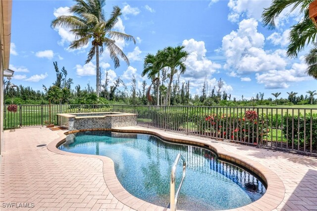 view of swimming pool featuring a patio and an in ground hot tub