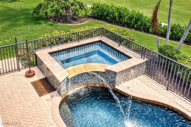 view of pool featuring pool water feature and an in ground hot tub