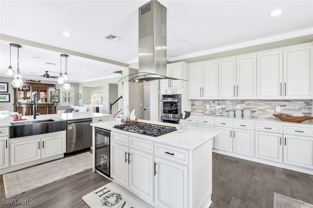 kitchen featuring beverage cooler, island exhaust hood, appliances with stainless steel finishes, a kitchen island, and white cabinets