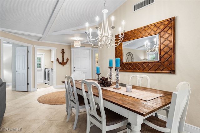 tiled dining space featuring separate washer and dryer and beamed ceiling