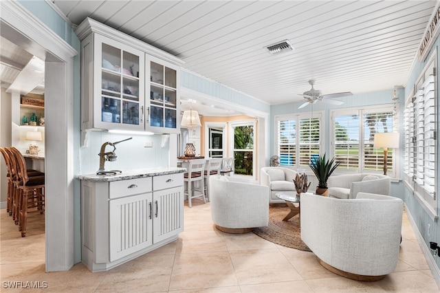 living room featuring ceiling fan and light tile patterned flooring